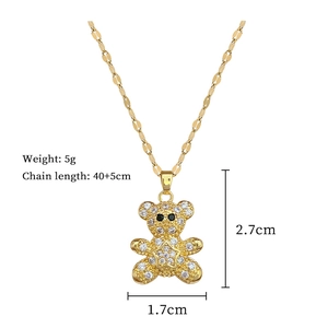 Detail view of gold teddy bear pendant with crystal studs and chain length measurements