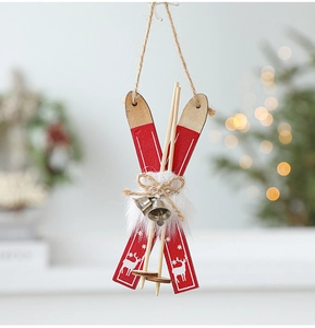 Detail of red wooden sled ornament with bells and fur trim for Christmas tree decor