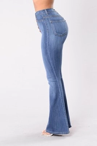 Side view of high waisted dark blue flared jeans showing slim fit and denim texture