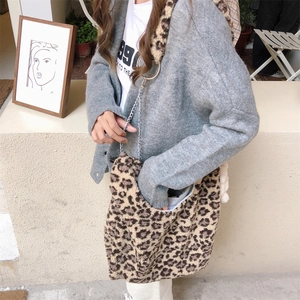 Detail of leopard print plush shoulder bag with metal chain strap and ring decoration