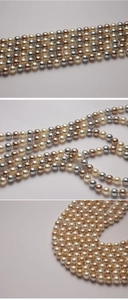 Macro shot of 8-12mm mixed color glass pearls in white, champagne gold, and silver grey