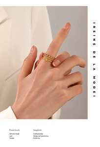 Detailed close-up of gold-plated stainless steel ring set with star charms on model finger