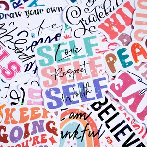 Close-up of holographic motivational vinyl stickers with glitter finish and self-love quotes
