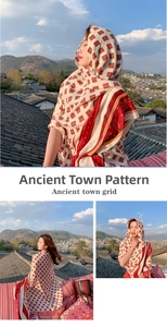 Close-up of retro ethnic pattern on light summer sun protection shawl with red plaid print