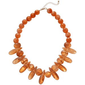 Bohemian style necklace with amber resin beads and marble texture on white background