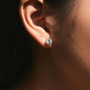 Close-up of model wearing 1 carat moissanite stud earring in 925 sterling silver