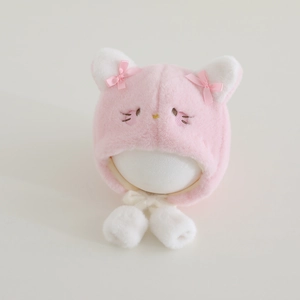 Detailed view of plush pink cat winter hat with cute ears and warm earflaps for girls
