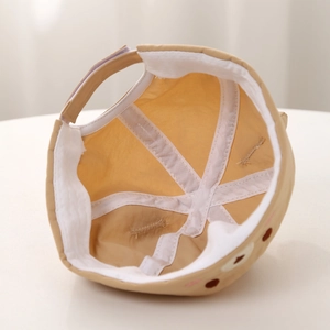 Detail view of baby docker hat interior featuring breathable holes and adjustable strap