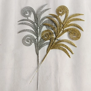 Detailed view of hollowed-out gold and silver glitter leaves for Christmas tree decoration