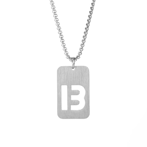 Macro shot of silver stainless steel pendant featuring a hollow number 13 and box chain