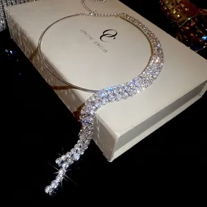 Elegant silver tassel collar necklace with rhinestone fringes on a jewelry box display