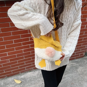 Detail of cute lamb wool duck crossbody bag featuring soft plush texture and yellow strap