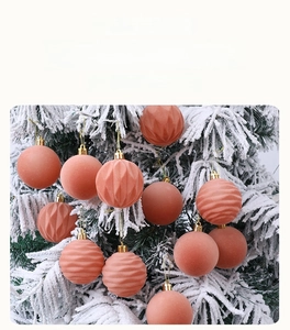 Detailed close-up of pink Christmas ornaments with matte and textured finishes on a tree