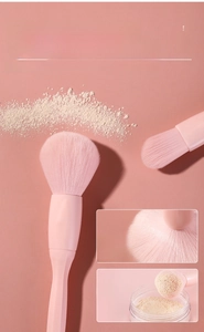 Close-up of pink powder brush bristles showing fine texture and powder pickup