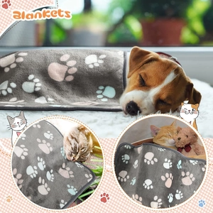 Detailed view of soft flannel pet blanket with colorful paw prints for dogs and cats