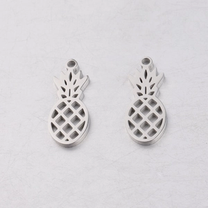Macro shot of polished stainless steel pineapple pendants with a hollow design