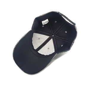 Inside view of houndstooth baseball cap showing 100% cotton lining and stitching