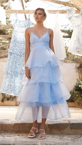Detail of light blue backless tiered dress with thin straps and ruffled tulle layers