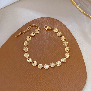Bracciale minimalista in acciaio al titanio dorato con dischi a motivo raggio di sole