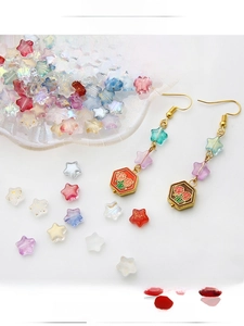 Detailed view of colorful star glass beads and handmade earrings for DIY jewelry making