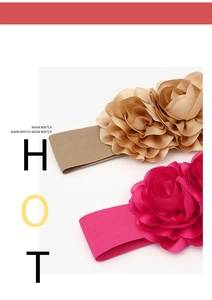 Detail of bohemian elastic flower belts in beige and rose red with 3D floral petals