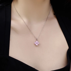 S925 sterling silver necklace featuring pink heart-shaped clover pendant on model