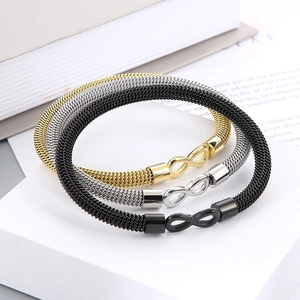 Detail of infinity symbol mesh bracelets in gold, silver, and black stainless steel