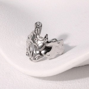 Macro detail of irregular silver stainless steel ring with a fluid molten metal texture