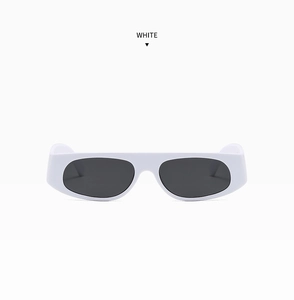 Close-up of white minimalist rectangle sunglasses with thick frames and dark lenses