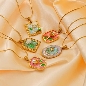 Detailed close-up of vintage floral enamel necklaces with gold-plated chains and pendants