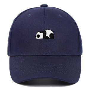 Close-up of detailed panda embroidery on a navy blue cotton baseball cap with fine stitching