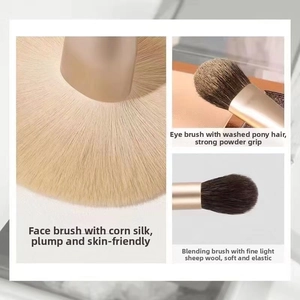 Macro detail of champagne gold makeup brushes featuring soft goat and pony hair bristles