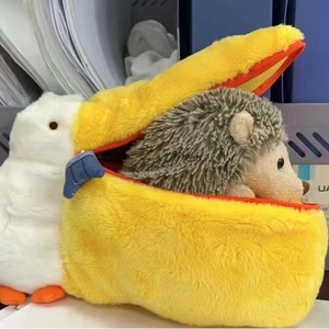 Macro shot of large plush pelican bag with small hedgehog hidden inside zipper pouch