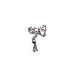 Silver bow stud earring with heart zircon and teardrop pendant on white background