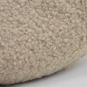 Close-up of soft beige textured wool fabric on a stylish newsboy cap for women