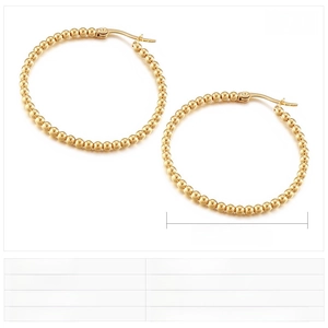 Detail view of 39mm wide gold stainless steel hoop earrings with beaded texture