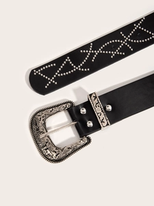 Close-up of black punk belt with silver studs and intricate embossed metal buckle