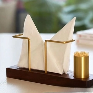Detail of walnut wood base and golden metal frame for tissues and toothpicks