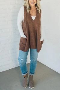 Detail of brown V-neck knitted vest with side pockets paired with denim jeans