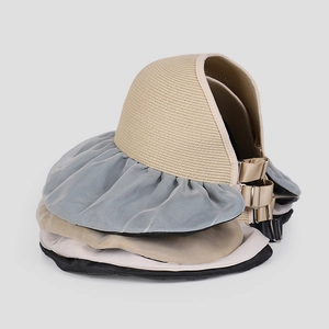 Adjustable metal buckle and straw texture detail on foldable organza sun hat