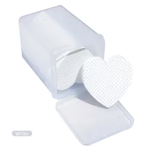 Macro shot of heart-shaped embossed non-woven makeup pads in a clear plastic storage box