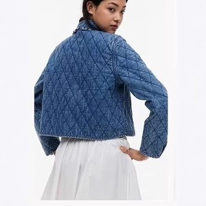 Women's blue denim bomber jacket featuring quilted diamond patterns and ruffle trim back