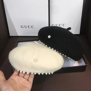 Women's wool beret hat with pearl trim and metal M logo in black and beige colors