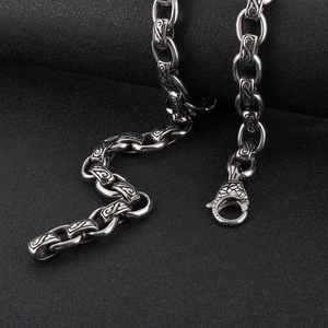 Macro detail of silver vintage 12mm O-chain necklace with engraved patterns and lobster clasp