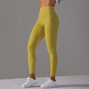Close-up of mustard high-waisted yoga leggings with seamless design and compression fabric