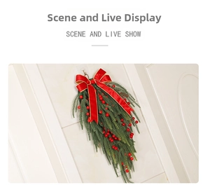 Detail of Christmas teardrop swag with red berries and velvet bow on white door