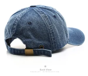 Detail view of the washed denim baseball cap featuring an adjustable brass metal buckle