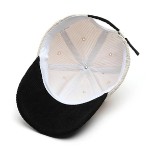 Inside view of two-tone corduroy baseball cap with adjustable strap and reinforced stitching