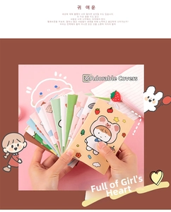 Close-up of portable mini notebooks featuring various cute pastel cartoon animal covers