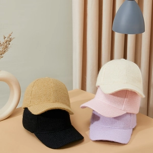 Knitted baseball caps in assorted colors including beige black and pink for winter warmth